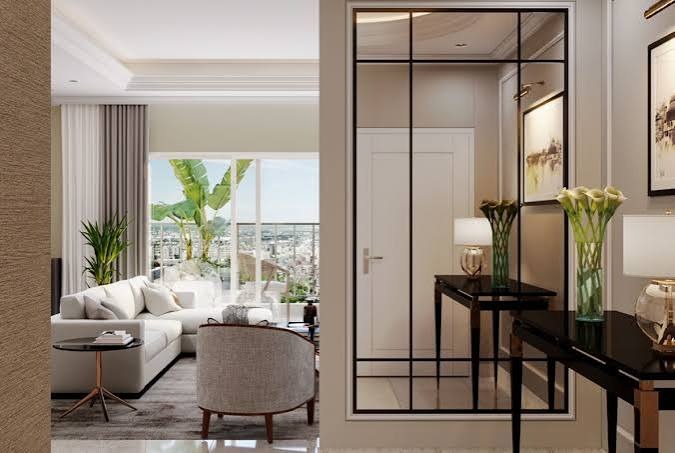 Living room opening onto a foyer with a glazed partition in a D2 residence