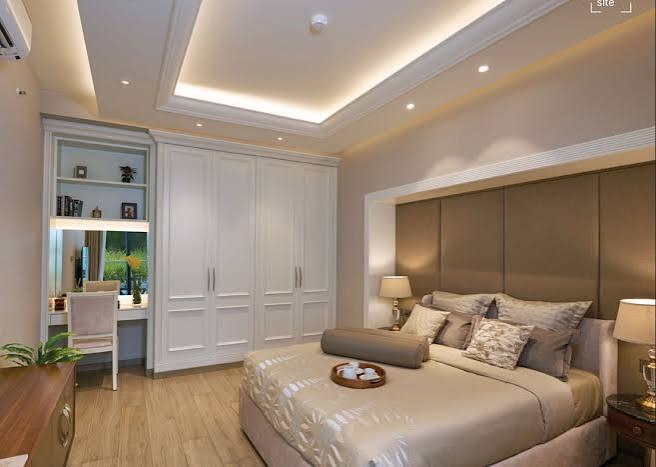 Bedroom with fitted wardrobes and a study nook in a D1 residence